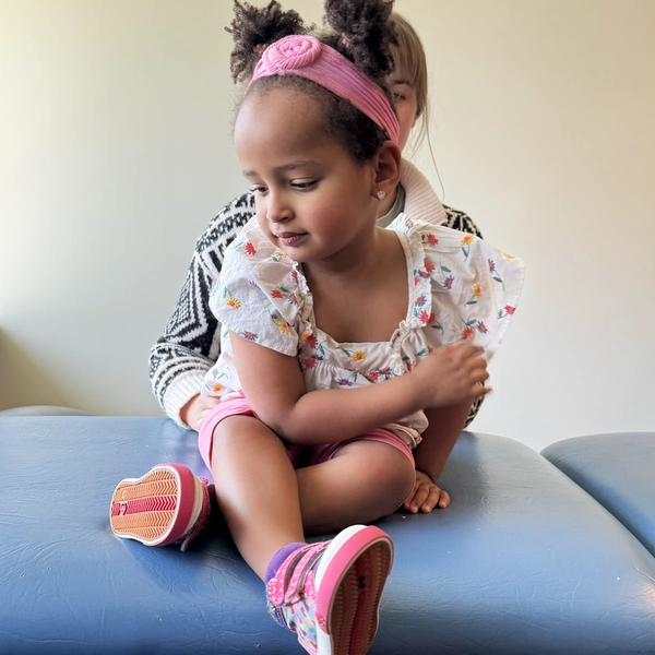 dmi girl sitting cross legged