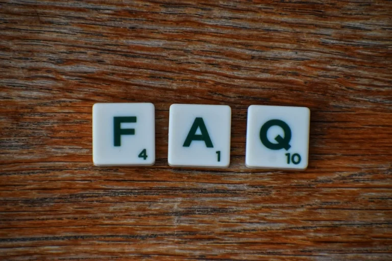 Intro to FAQ page with 3 scrabble letters F, A and Q on a wooden table